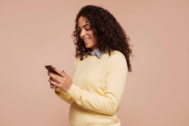 istock Young multiracial girl uses smartphone application 1484773878