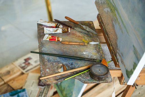 Close-up of paintbrushes and paints used by painters