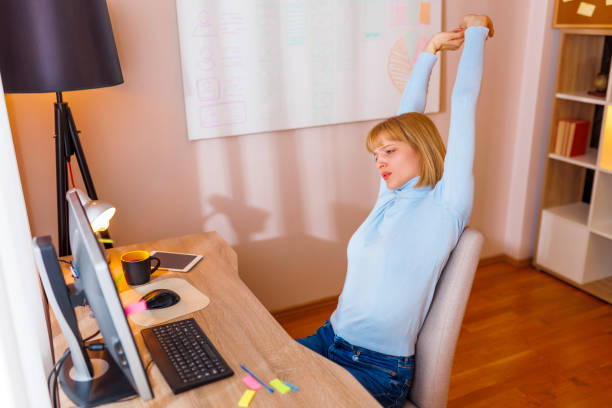 istock Woman stretching out while working in an office 1484775439