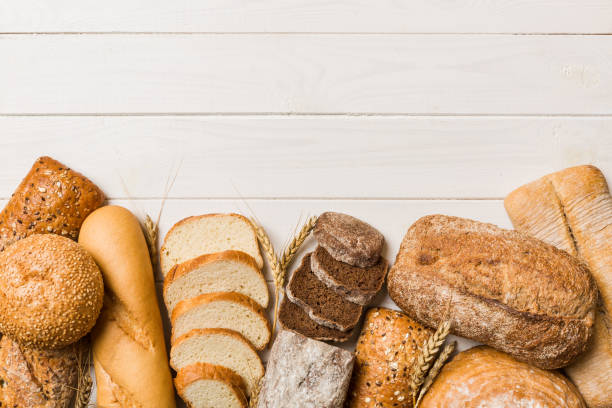 istock Homemade natural breads. Different kinds of fresh bread as background, top view with copy space 1484777132