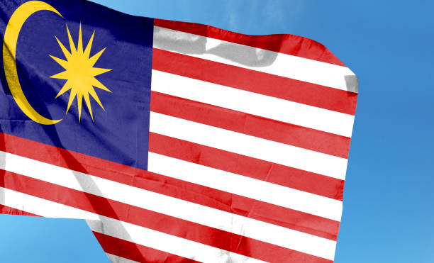 istock Malaysian flag in the cloudy sky. waving in the sky 1484777331