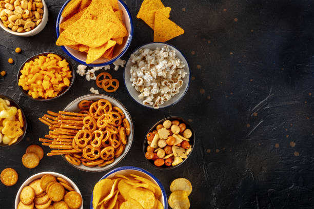 istock Salty snacks, party mix, overhead flat lay shot with copy space 1484777382