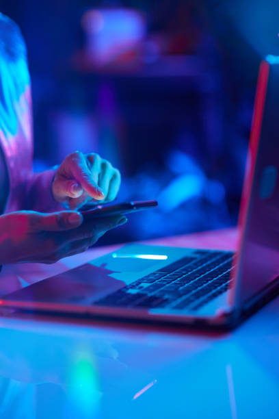 istock Closeup on woman using laptop and using smartphone app 1484779040