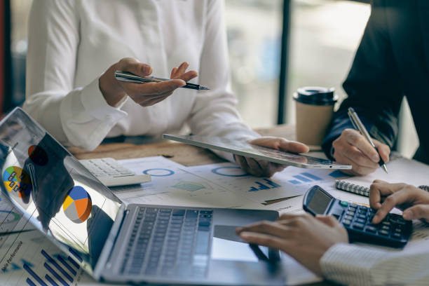istock Asian business people meeting, planning and discussing chart data analysis. financial calculations and business efficiency Accounting concept. Marketing. Teamwork with analytical price charts. 1484779547