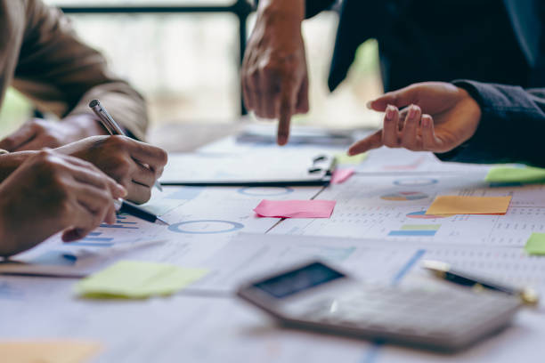 istock Asian business people meeting, planning and discussing chart data analysis. financial calculations and business efficiency Accounting concept. Marketing. Teamwork with analytical price charts. 1484779570