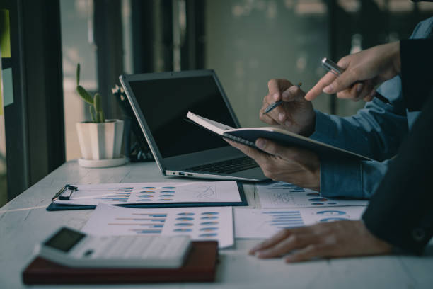 istock Asian business people meeting, planning and discussing chart data analysis. financial calculations and business efficiency Accounting concept. Marketing. Teamwork with analytical price charts. 1484779755