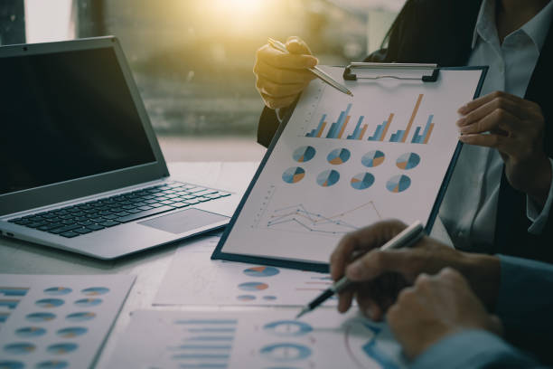istock Asian business people meeting, planning and discussing chart data analysis. financial calculations and business efficiency Accounting concept. Marketing. Teamwork with analytical price charts. 1484779756