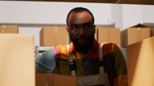 istock Young man organizing boxes in depot 1484780964