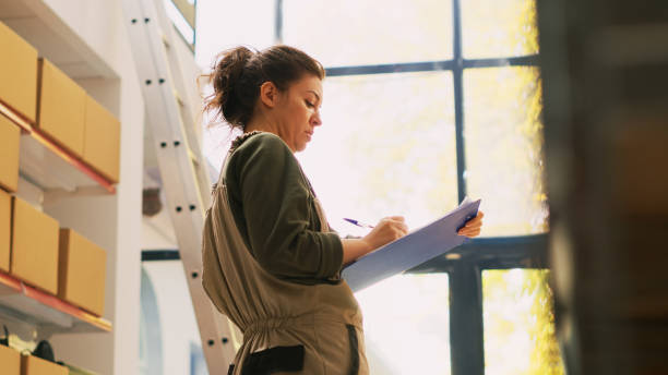 istock Young adult verifying inventory list 1484781232