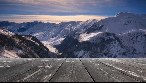 istock Beautiful winter sunset over mountains with empty wooden table. Natural template landscape 1484781706