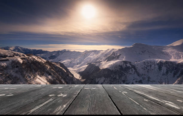 istock Beautiful winter sunset over mountains with empty wooden table. Natural template landscape 1484781818