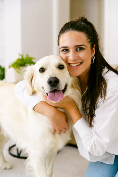 istock Girl cuddle with her dog at home 1484781920
