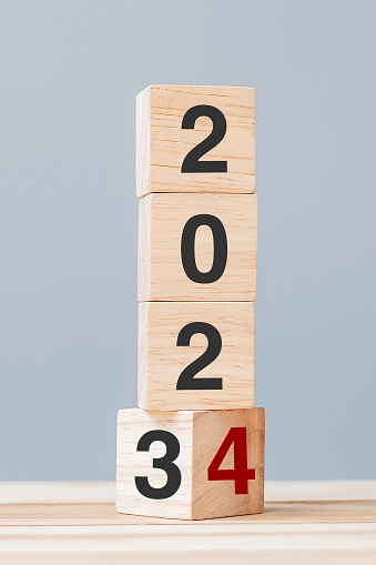 2023 chang to 2024 wooden cube blocks on table background. Resolution, plan, review, goal, start, end year  and New Year holiday concepts
