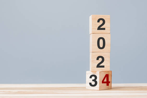 istock 2023 chang to 2024 wooden cube blocks on table background. Resolution, plan, review, goal, start, end year  and New Year holiday concepts 1484781979