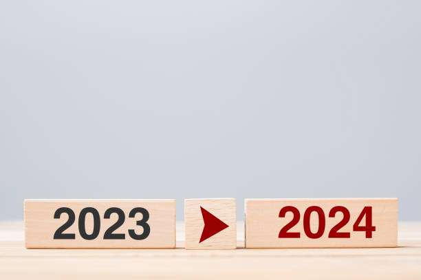 istock 2024 and 2023 wooden block on table background. Resolution, strategy, countdown, goal, change and New Year holiday concepts 1484782106