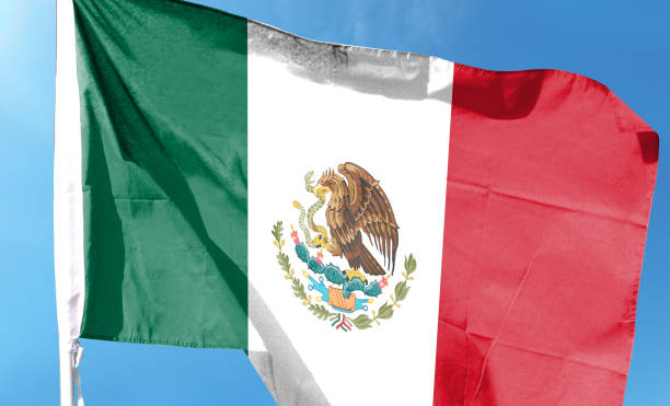 istock Mexican flag in cloudy sky. waving in the sky 1484784767