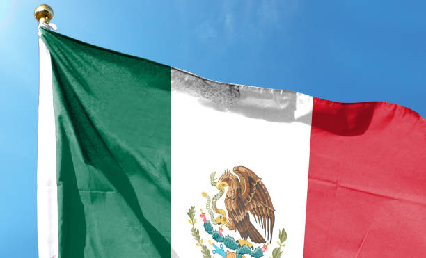 istock Mexican flag in cloudy sky. waving in the sky 1484784853
