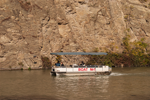 Georgia, Tbilisi - October 30, 2022: Tourists ride on a pleasure boat along the Mtkvari, Kura River
