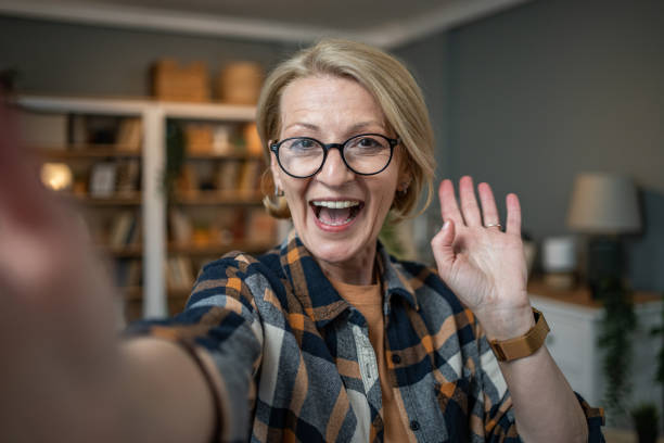 istock Caucasian mature woman taking selfie or video call using mobile phone or vlog camera having happy facial expressions 1484785863