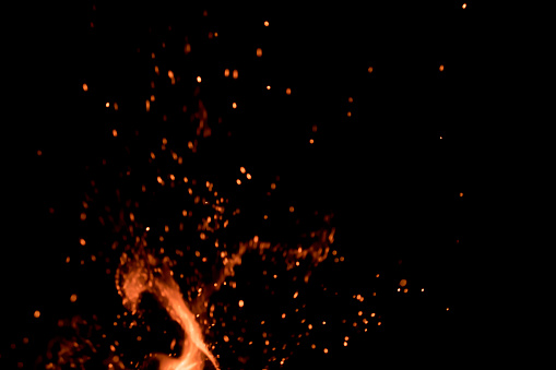 Blured fire sparks with spurt of flame; selective focus; overlay design usage