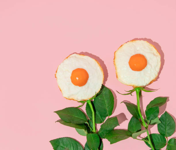 istock Spring creative layout with fried eggs and rose flower stems on pastel pink background. 80s or 90s retro fashion aesthetic bloom concept. Minimal romantic surreal cosmetic idea. 1484788962