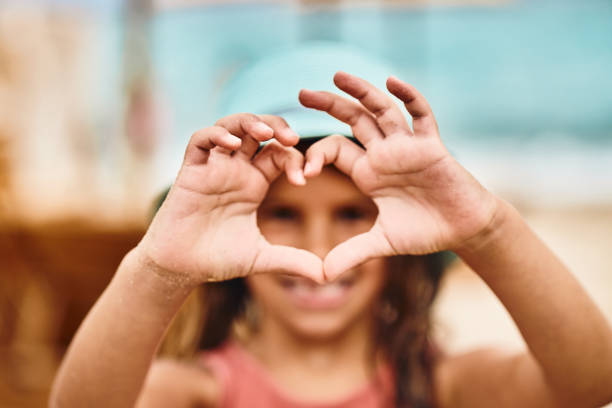 istock Beautiful girl making heart shape 1484789360