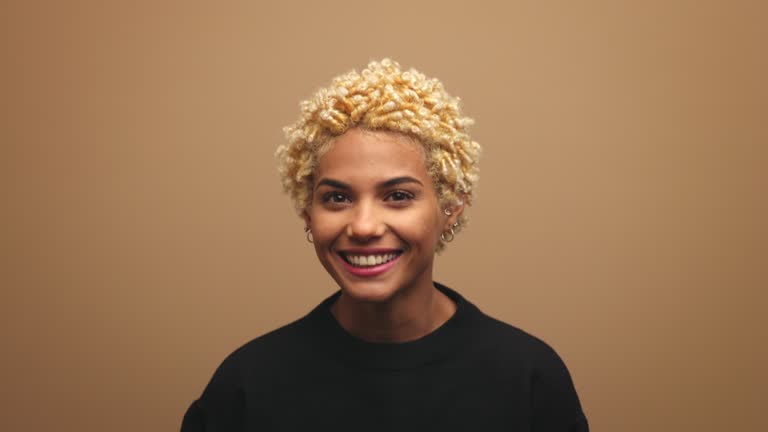 Happy blond young woman wearing black sweatshirt