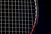 Closeup of Badminton Racket Frame and Strings on a Dark Blue Background