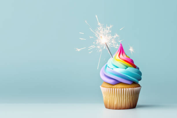 istock Birthday rainbow cupcake with celebration sparkler 1484791989