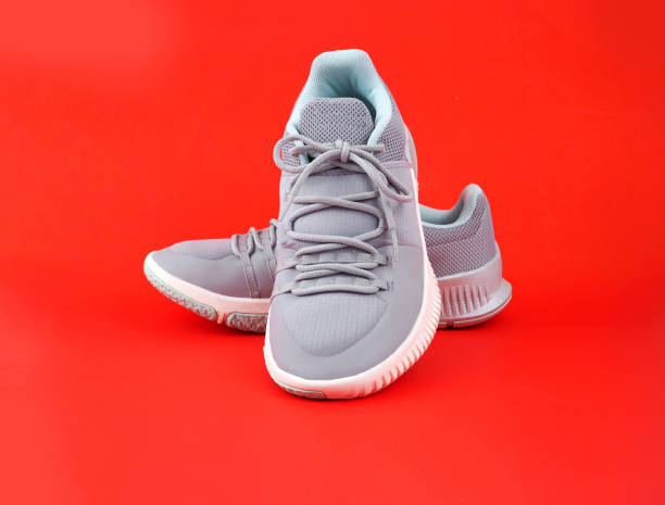 istock New Grey-light green sneakers isolated on red background. 1484792537