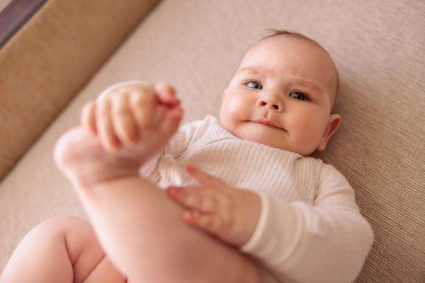 istock Cute playful baby boy lying on the couch 1484794360