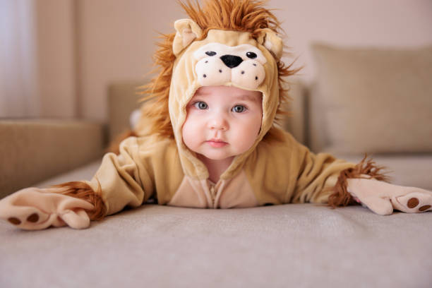 Playful baby boy in lion costume stock photo