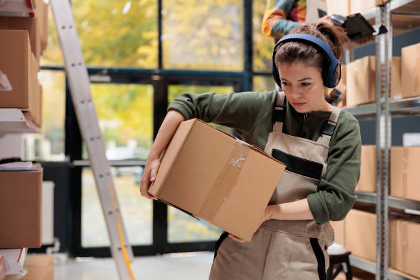 istock Storehouse worker carrying carton box analyzing checklist 1484794789