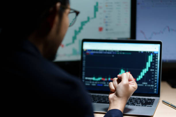 istock Successful Businessman Sitting at Desk Using Laptop Computer, Celebrate Success. 1484796673
