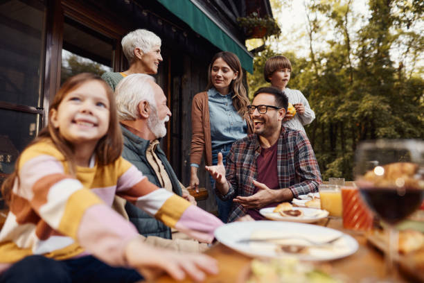 istock Happy extended family talking while having lunch on a terrace. 1484797124