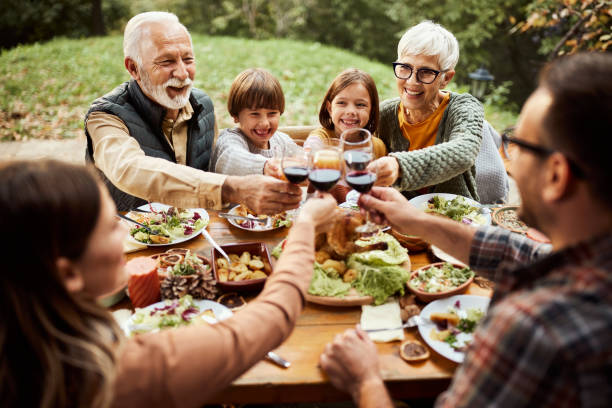 istock Happy extended family toasting during lunch on a patio. 1484797479