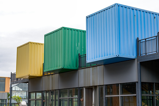 Three colored shipping containers make residential buildings