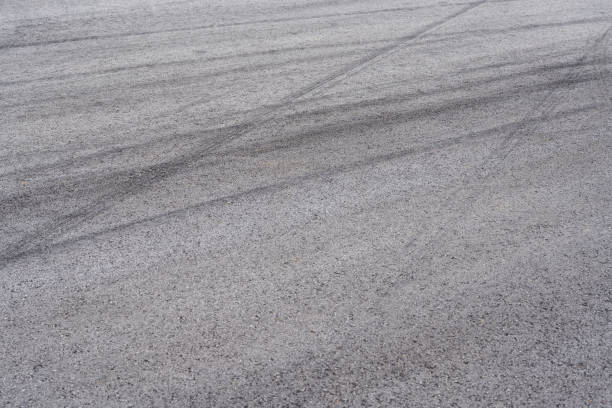 istock Car tire slamming marks on asphalt road 1484798124
