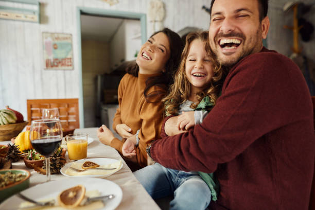 istock Young cheerful family enjoying in dining room. 1484798148
