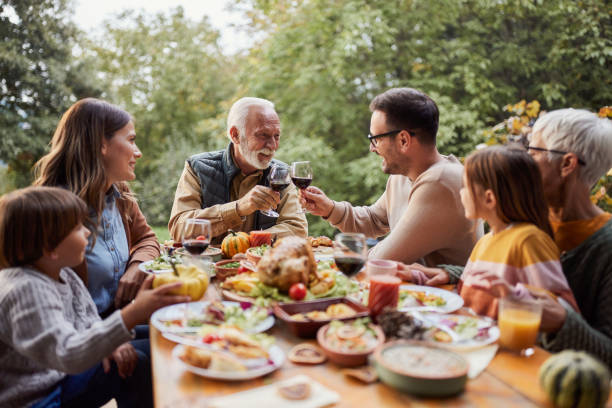 istock Happy multi-generation family enjoying in lunch on a terrace. 1484799201