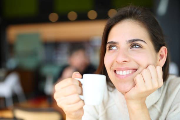 istock Happy woman dreaming drinking coffee 1484801339