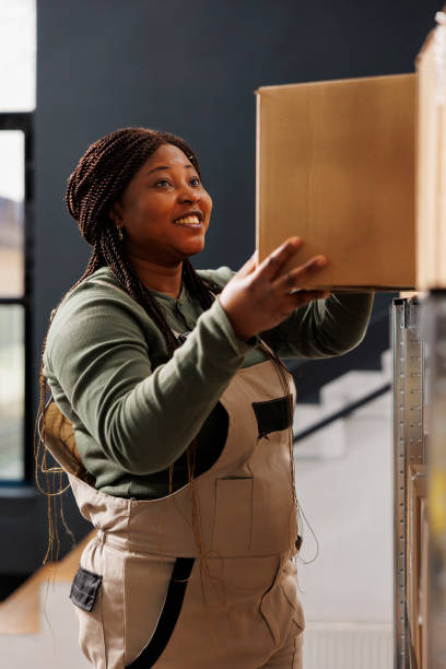 istock Stockroom worker taking out cardboard box from shelves 1484801450