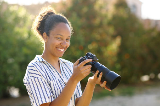 istock Happy black photographer posing 1484801459