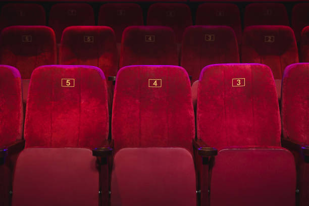 istock Empty comfortable red seats with numbers in the cinema 1484801957