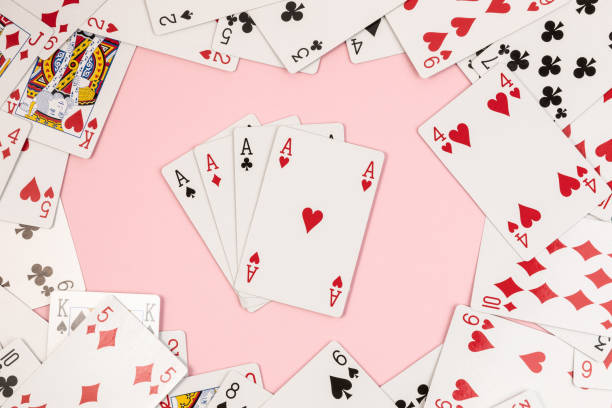 istock Poker playing cards on pink background 1484802873
