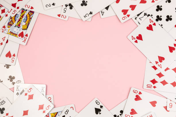 istock Poker playing cards on pink background 1484803783
