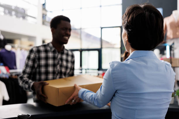 istock Man standing at store counter desk 1484805109