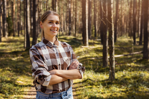 smiling female forester or forest owner. forestry and forest management