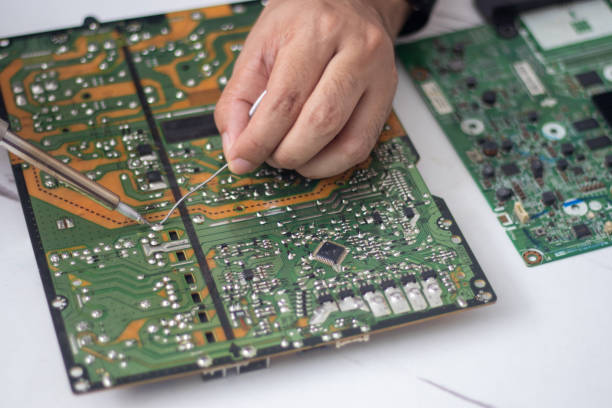 istock Technician using a soldering iron to repair a circuit board 1484813504