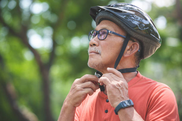 istock Asian Senior Cyclist man putting Helmet 1484816703